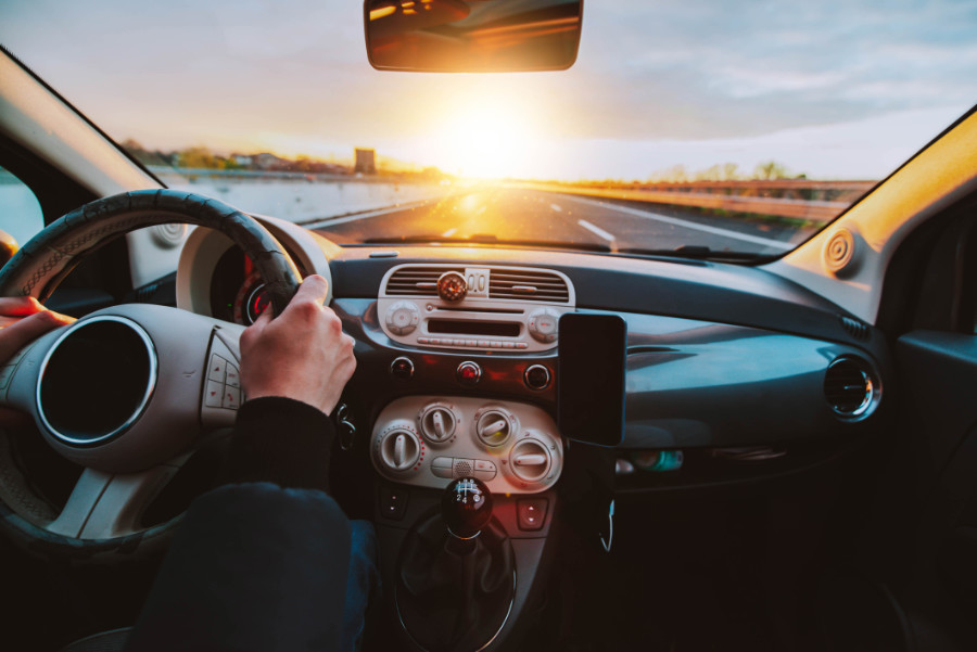 Rear view of man driving car on the highway - Transportation lif
